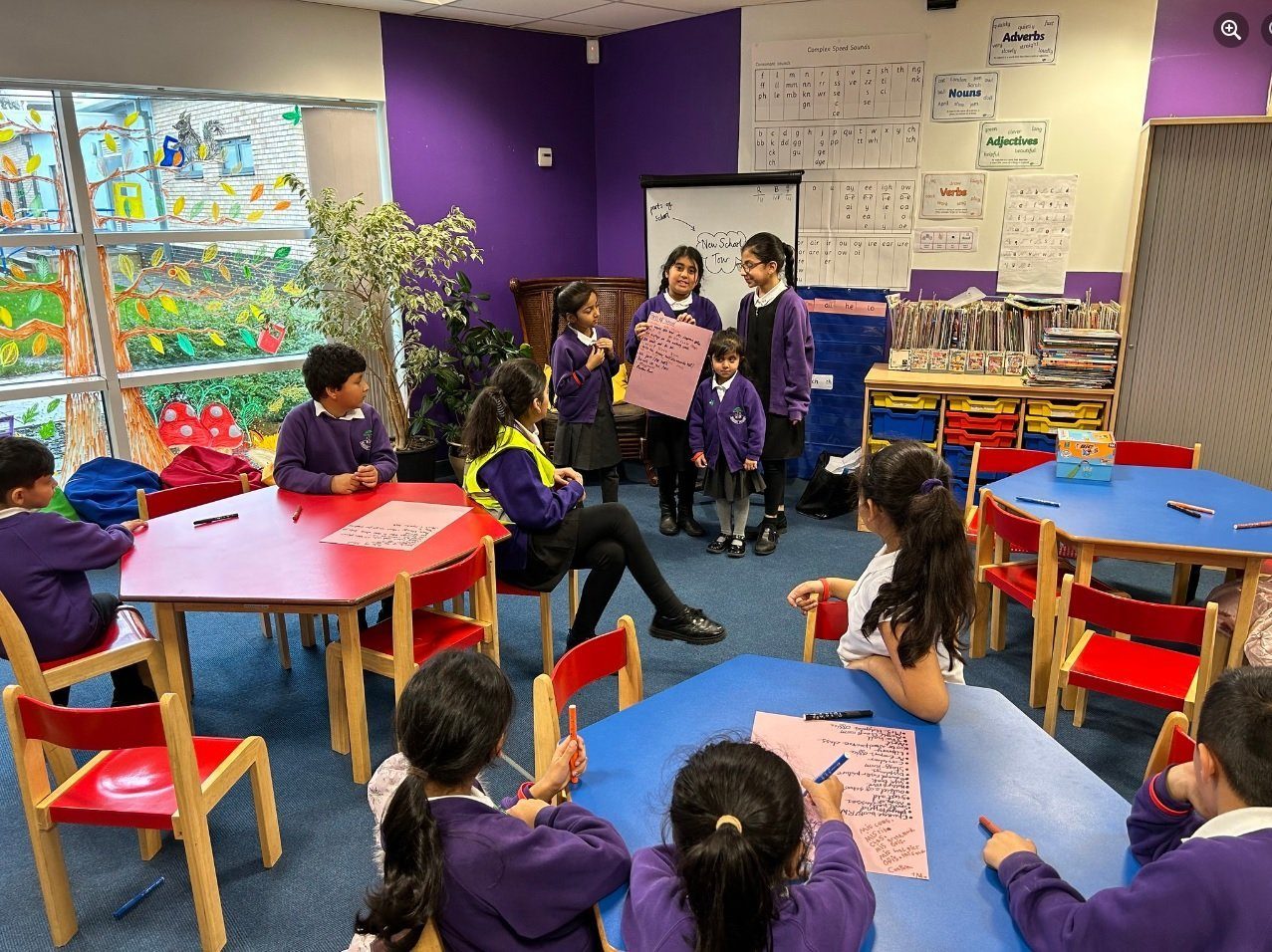 A whole class taking part in a school council meeting at their desks